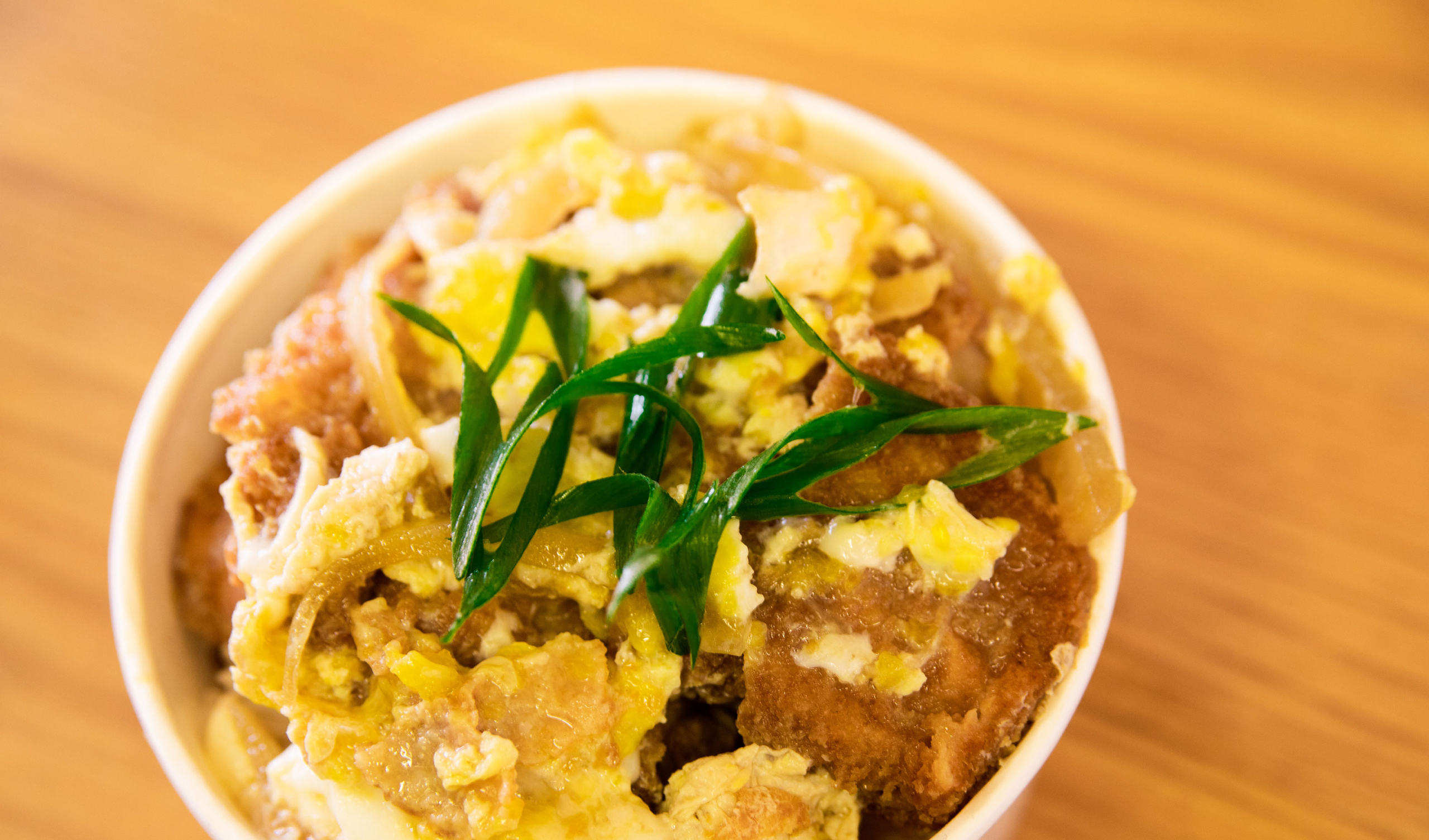 Katsu Don - Pork cutlet, caramelized onion, egg and house donburi sauce on bowl of rice